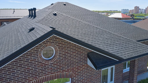 A view of the roof of a home from above showing asphalt shingles